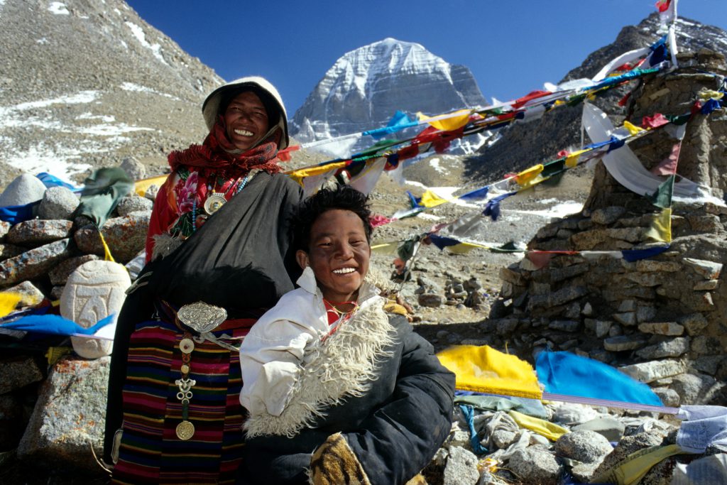 Pilger vor aufgespannten Gebetsfahnen am heiligen Berg Kailash, Tibet; Foto: Dieter Glogowski, 2005