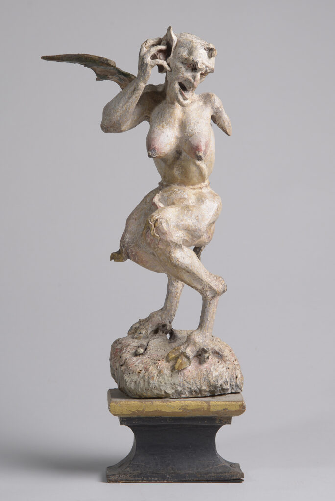 Groteske Teufelsfigur mit weiblichen Brüsten