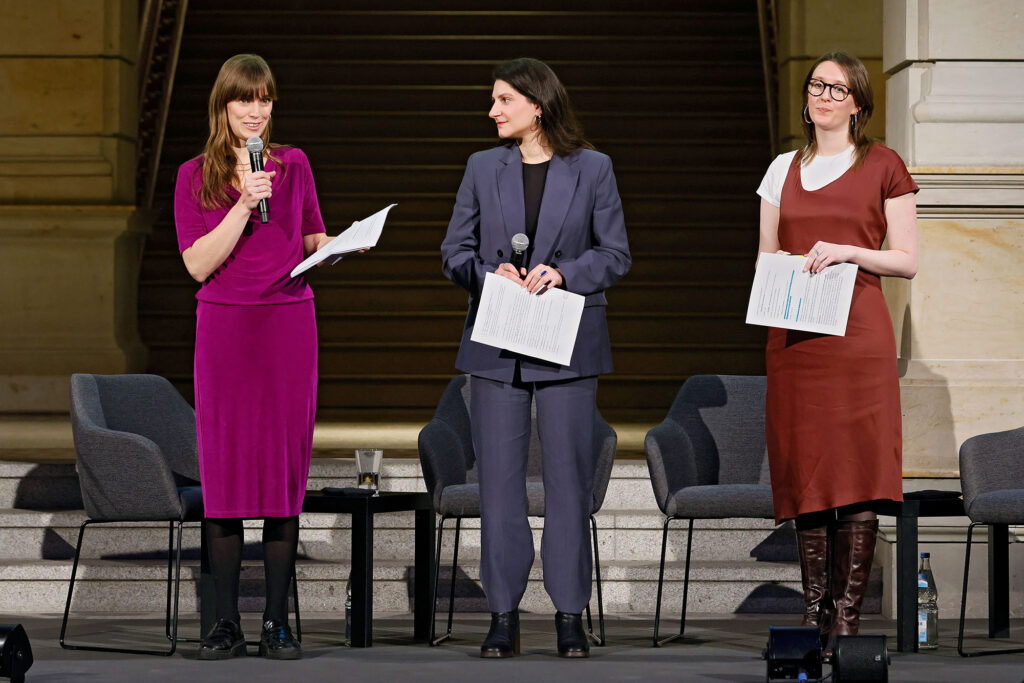 Drei junge Frauen auf einer Bühne